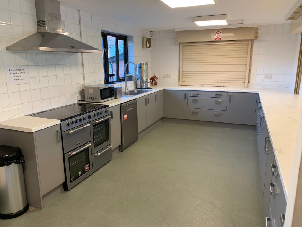 Modern kitchen facilities at Assington Village Hall, showcasing sleek countertops, stainless steel appliances, ample storage, and a clean, bright finish